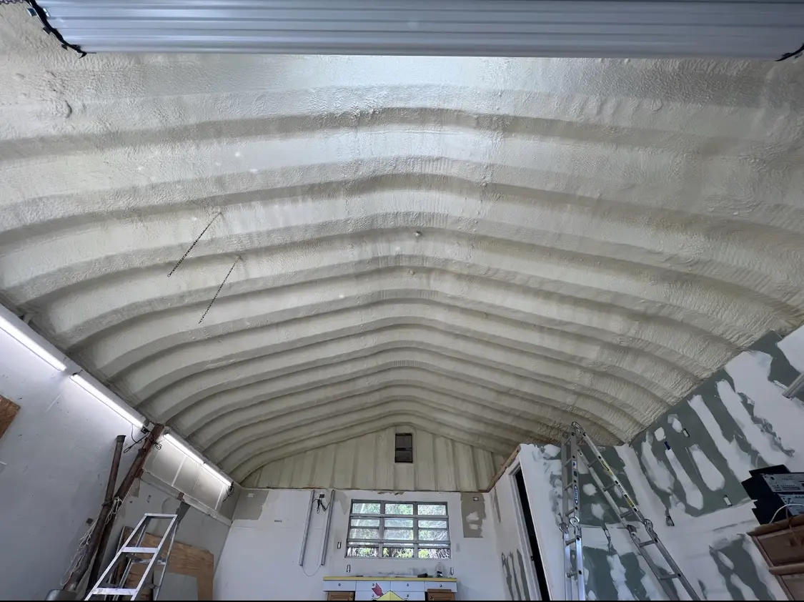 Spray polyurethane foam applied to the underside of a metal roof deck in Kochville